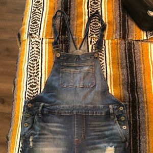 Distressed skinny denim overalls